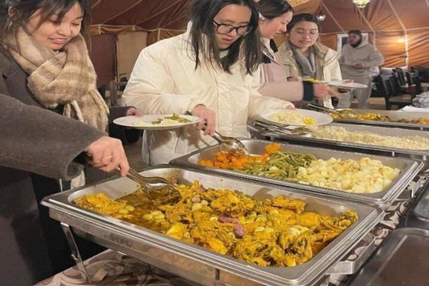 A buffet with various dishes, including rice, vegetables, and meat. 4