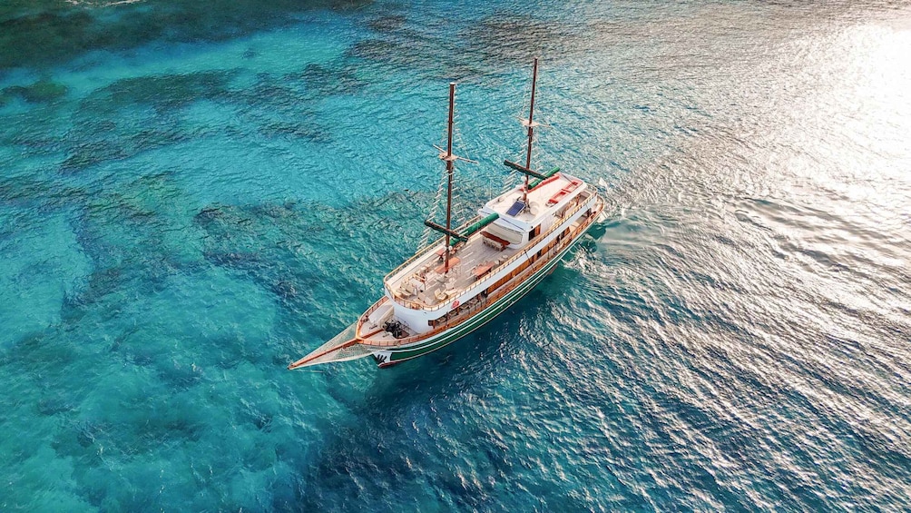 A sailing ship on clear turquoise waters. 1