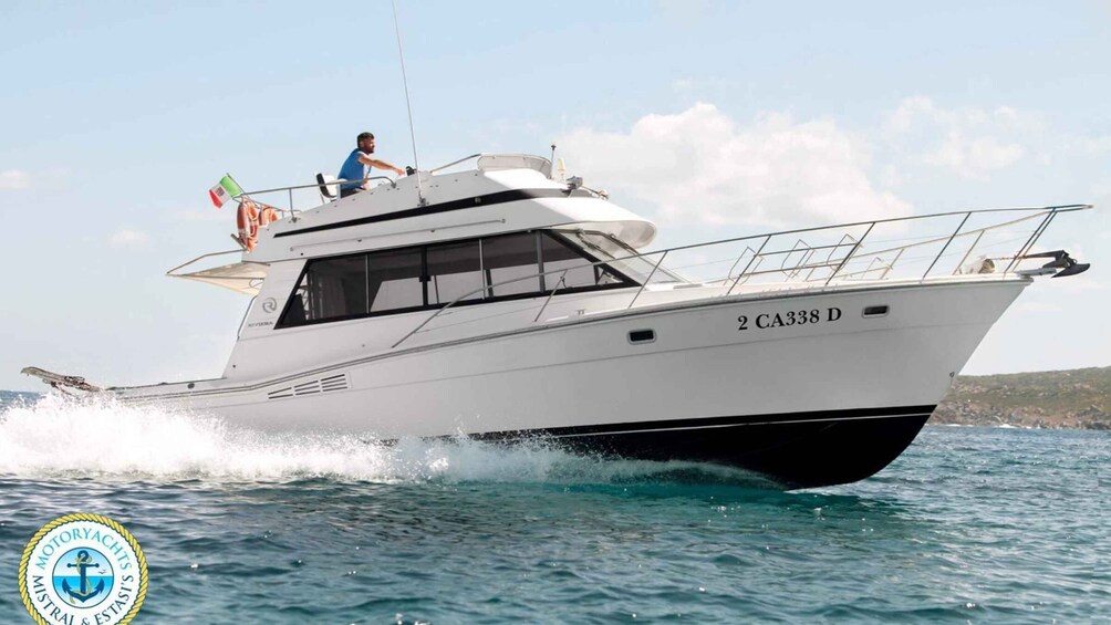 A white motor yacht with the registration number 2 CA338 D moving through the water. 1
