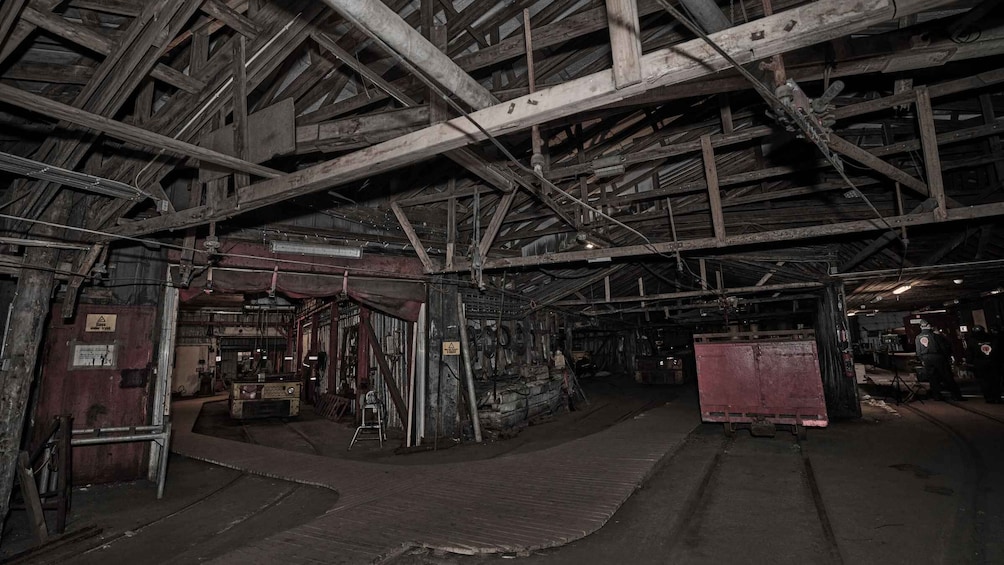 An industrial interior with exposed beams, metal structures, and machinery. 2