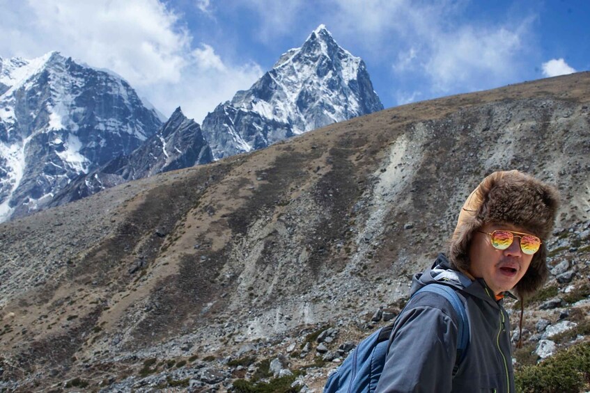 A person hiking with a mountainous landscape in the background. 2
