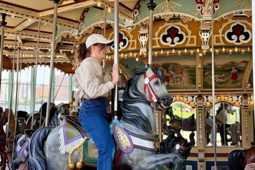 A carousel with a woman riding a horse. 2