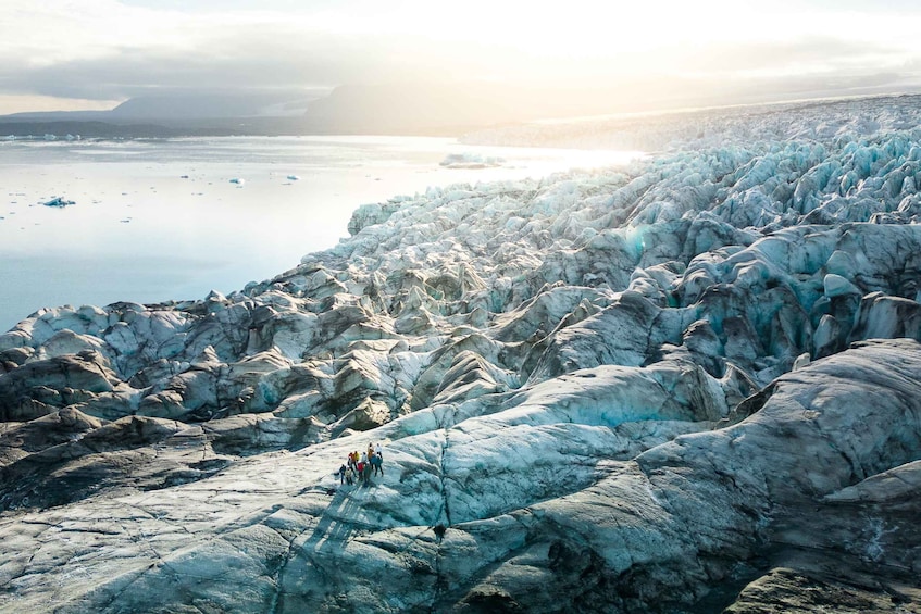 A glacier with people observing it. 5