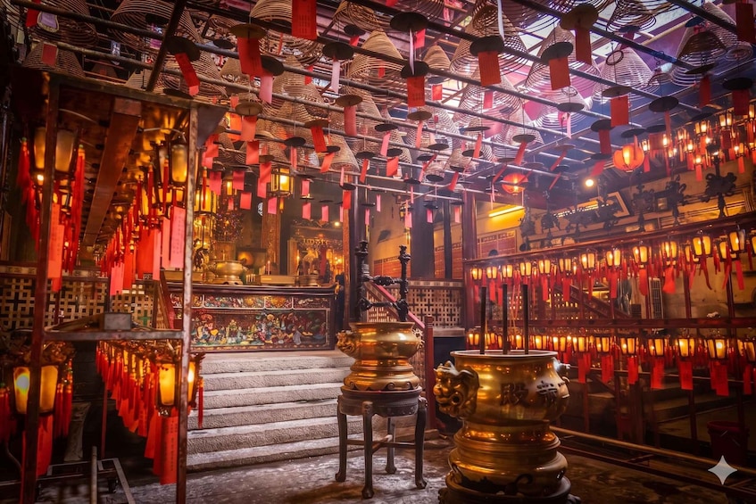 An ornate temple interior with red lanterns, golden statues, and intricate wall paintings. 1