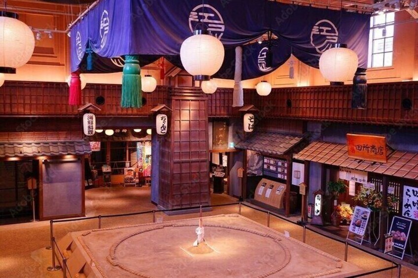Un ambiente interior japonés tradicional con suelo de tatami, estructuras de madera y linternas colgantes. 3