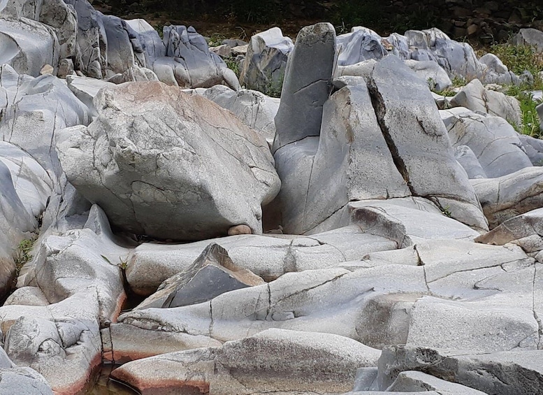A collection of large, rugged boulders in a natural setting. 2