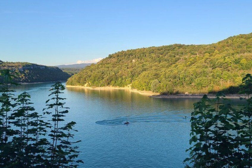 A calm lake surrounded by forested hills. 3