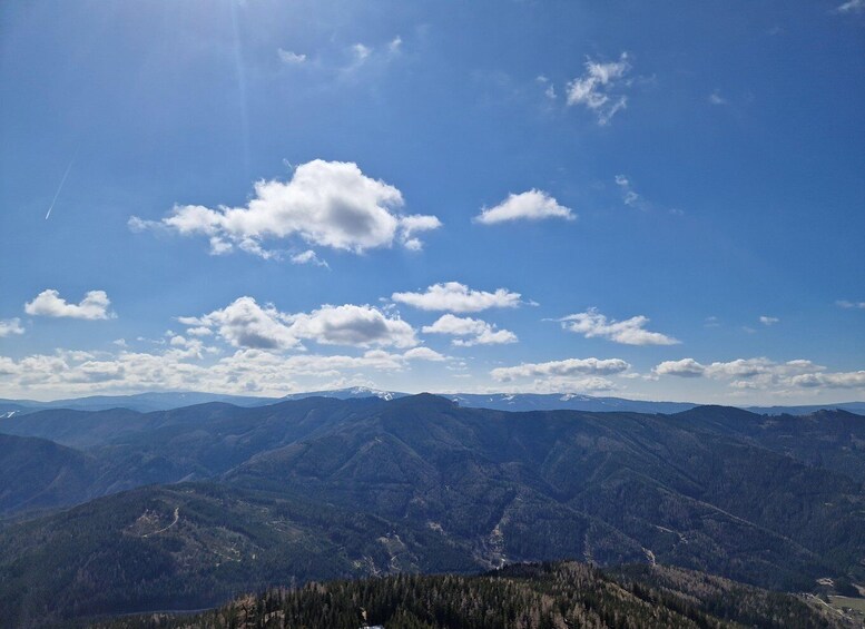 A mountain range with a clear sky and scattered clouds. 5