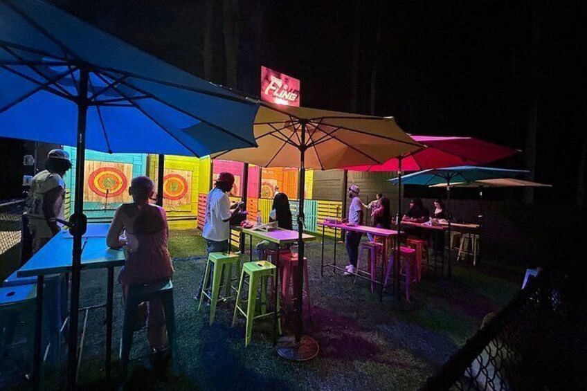 An outdoor dining area with colorful umbrellas and tables. 4
