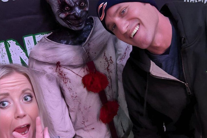 A person in a white dress with red flowers and bloodstains, and another person in a black jacket. 3
