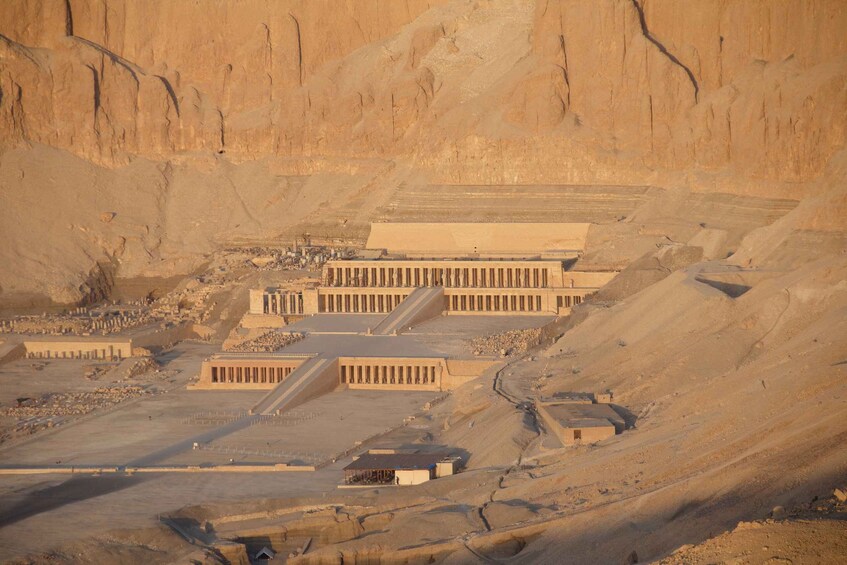A large, ancient Egyptian temple complex with multiple structures, including a large central building and smaller surrounding buildings. 2