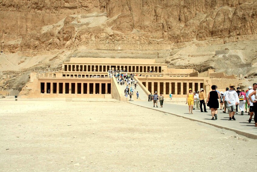 A large ancient Egyptian temple complex with a grand staircase leading to the entrance. 1