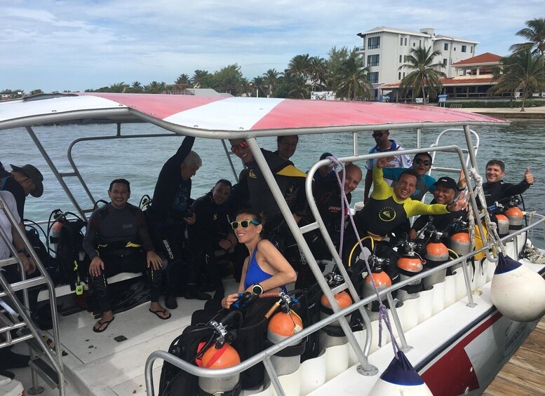 A group of people on a boat with scuba diving equipment. 2