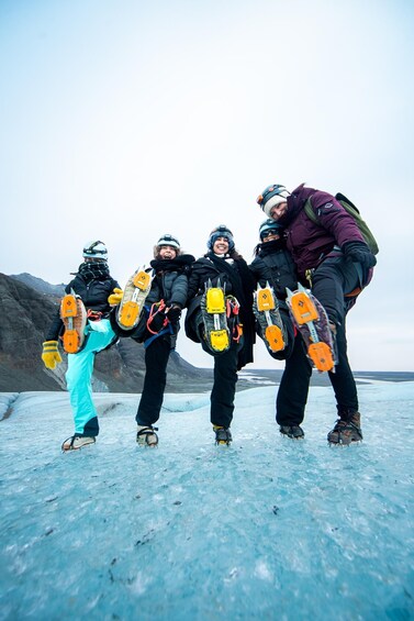 Four people ice skating on a glacier with safety gear. 5