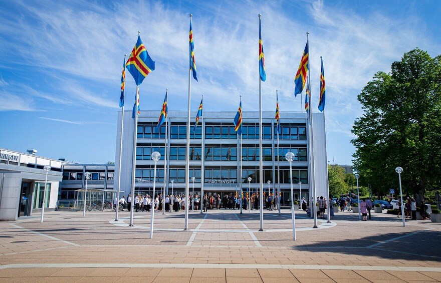 A modern building with multiple flags in front. 2