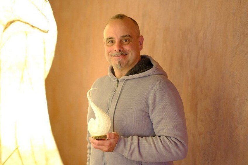 A person holding a large, white, swirled object. 3