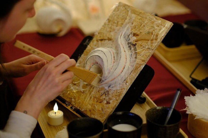 A person applying a substance to a surface with a brush. 4