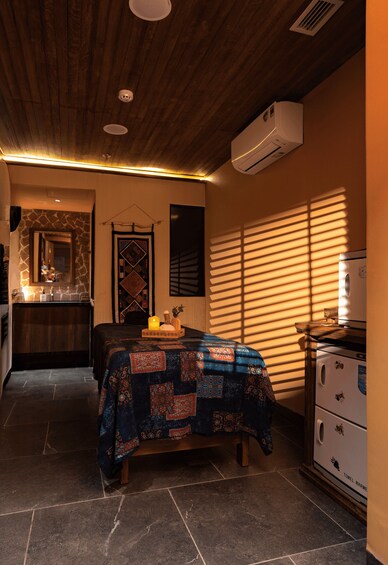 A room with a bed, a dresser, a mirror, and a window with blinds. 5