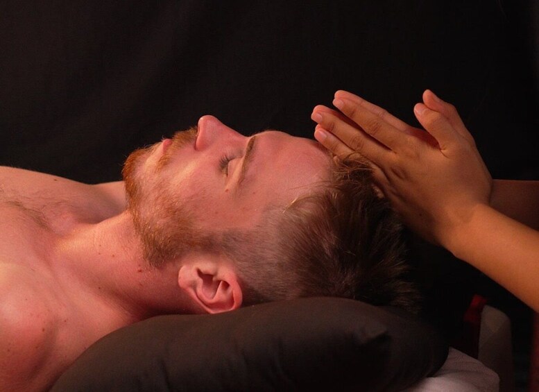 A person lying down with a pillow under their head. 3