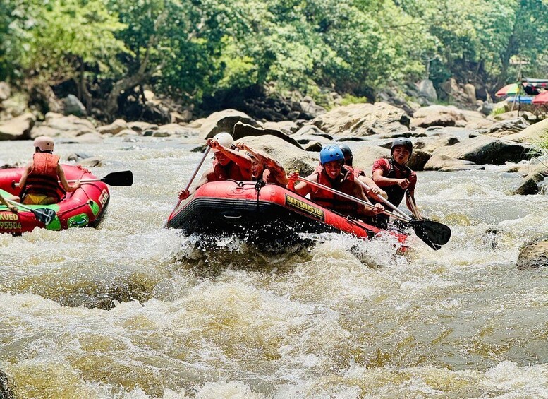 People rafting down a river with rapids. 1