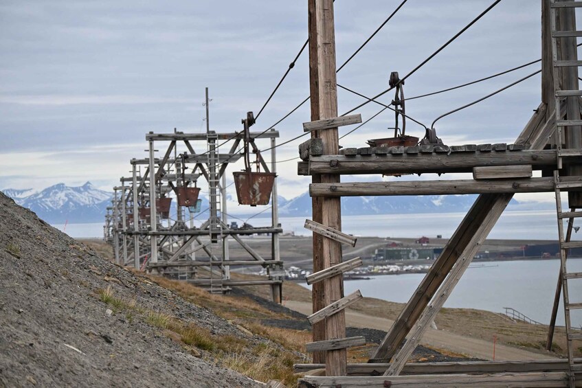A mountainous landscape with a wooden structure and a body of water in the background. 2