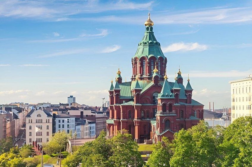 A large red church with green domes and golden spires, surrounded by trees and buildings. 4