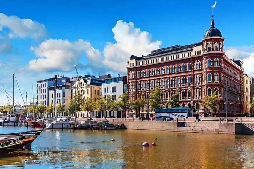 A waterfront with a red building, boats, and a clear sky. 2
