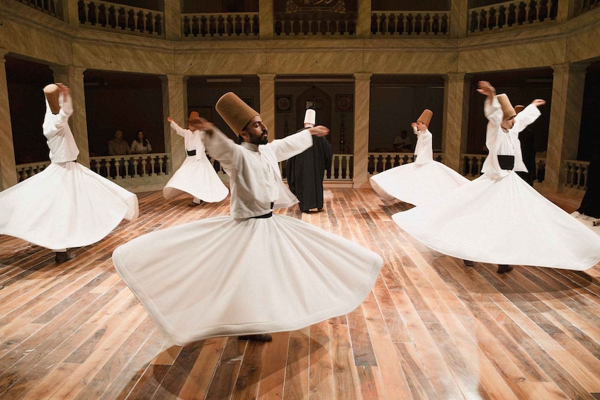 A dance performance in a historic building with marble floors and balconies. 5