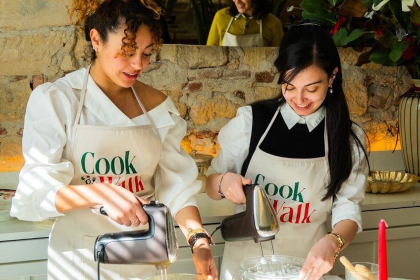 Two people wearing aprons with the text 'Cook Walk' engaged in cooking activities. 3