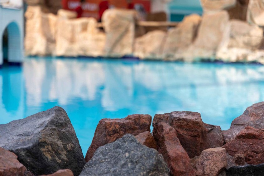 A pool surrounded by large rocks. 5