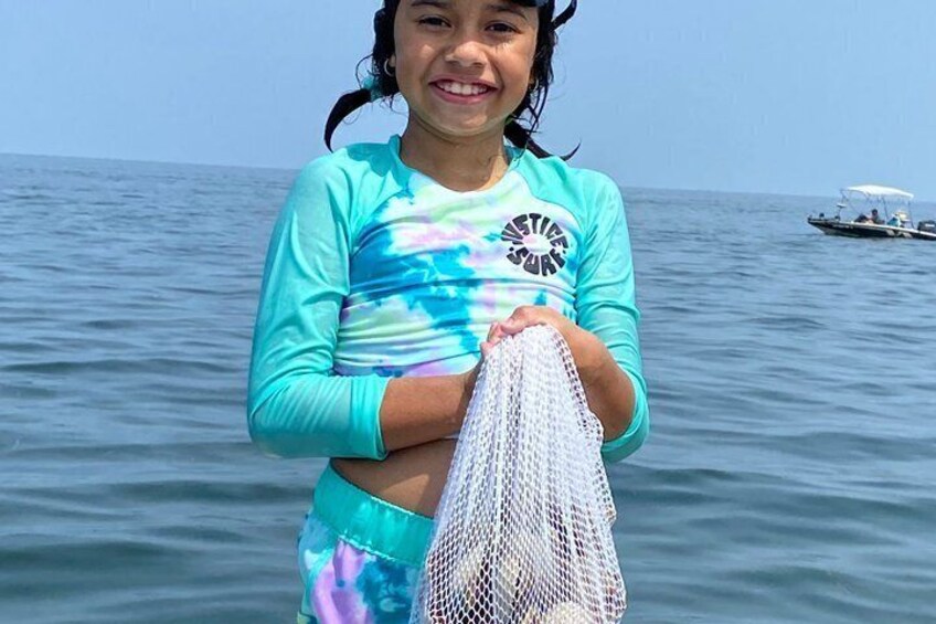 A person holding a fishing net on a boat in the ocean. 4