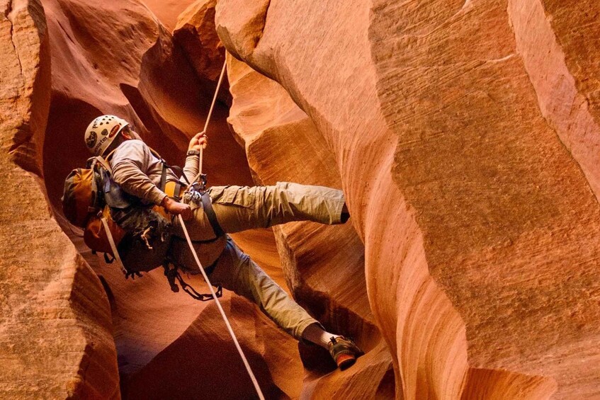 A person rock climbing in a canyon. 1