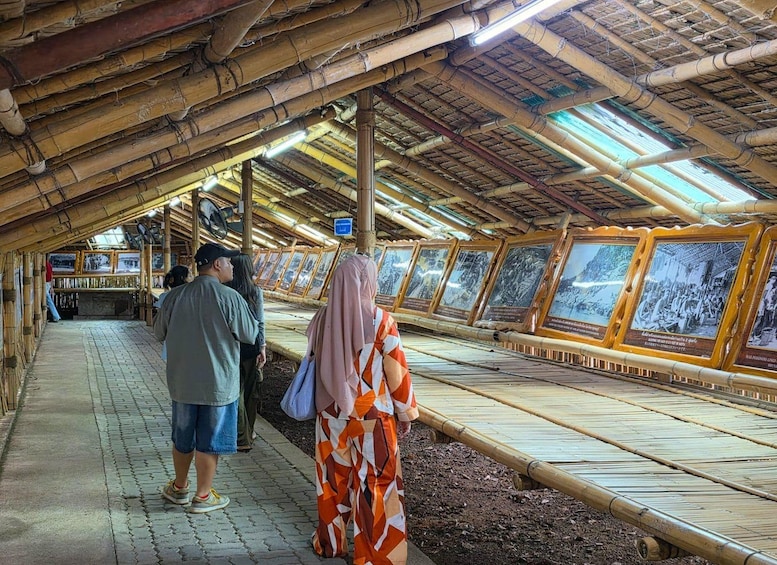 A bamboo structure with a tiled floor and a roof supported by bamboo poles. 5