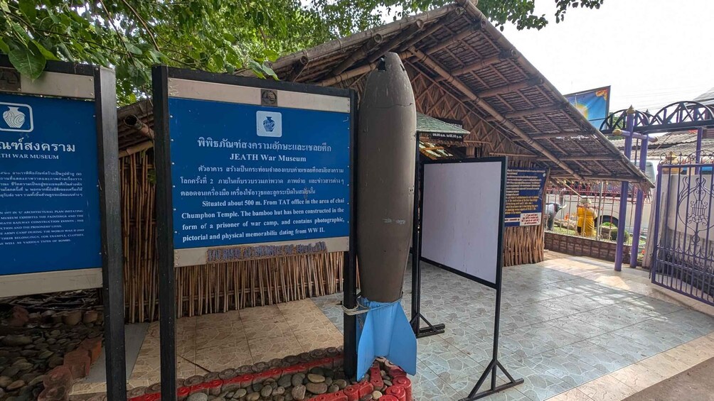 A Jeath War Museum with informational signs and a large bomb display. 3