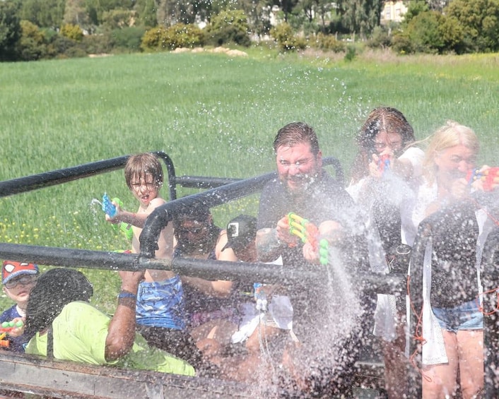People in a boat with water splashing around them. 2