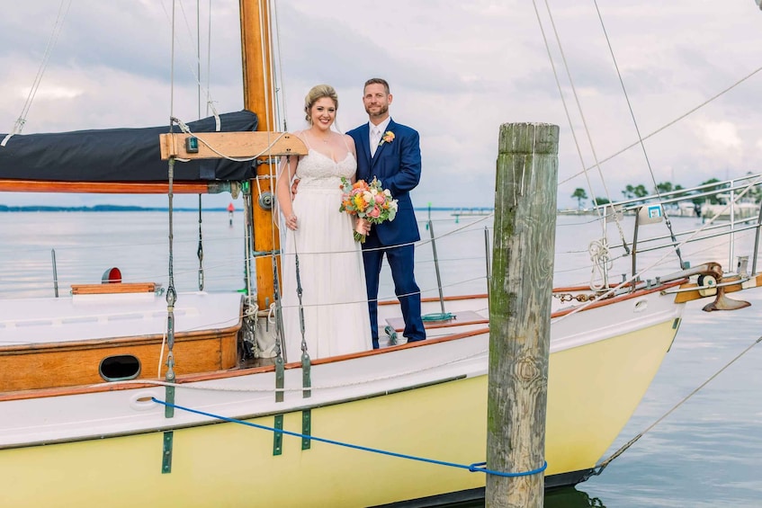 A couple on a sailboat with a wooden deck and a view of the water. 5