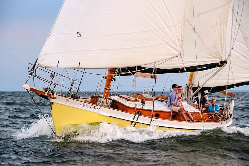 A sailboat named 'Lady Patty' with passengers on board, sailing on the ocean. 2