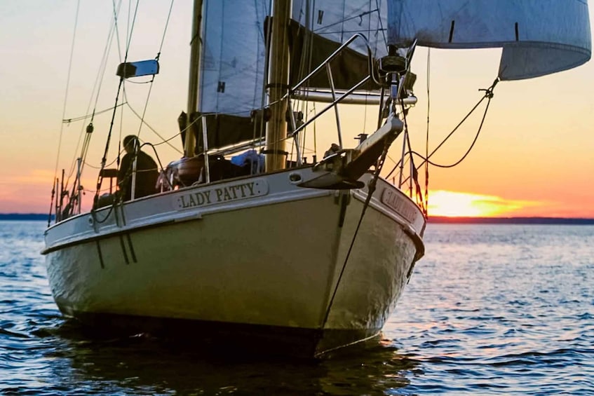 A sailboat named LADY PATTY on calm waters during sunset. 1