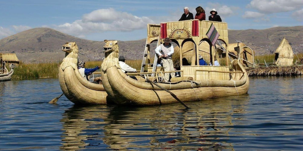 A traditional boat with woven design, people on board, and a mountainous landscape in the background. 3