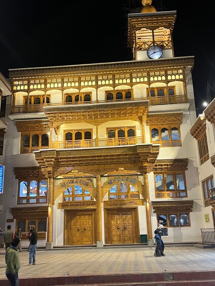 A traditional building with ornate wooden balconies and a clock tower. 3