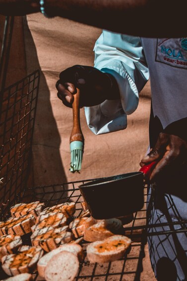 A person grilling bread slices on a wire rack. 2