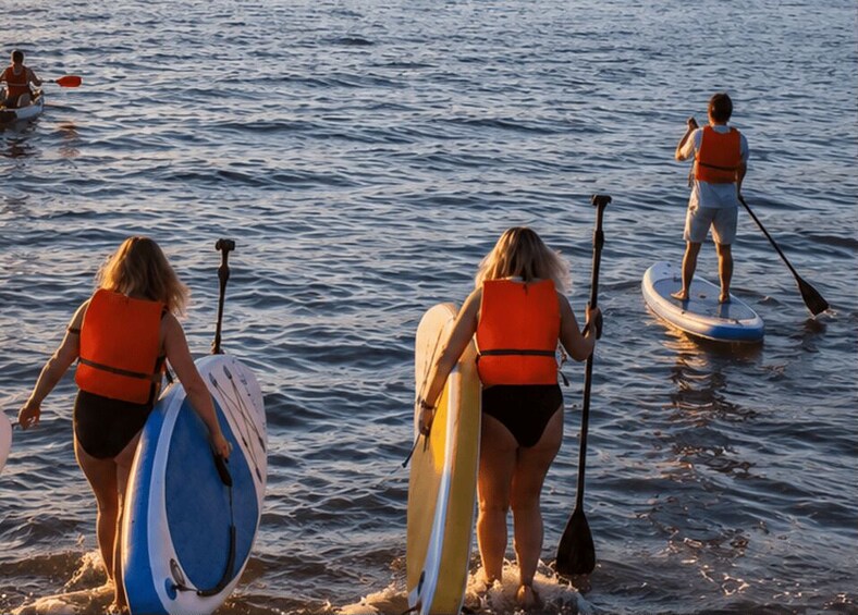People paddleboarding on a body of water. 4