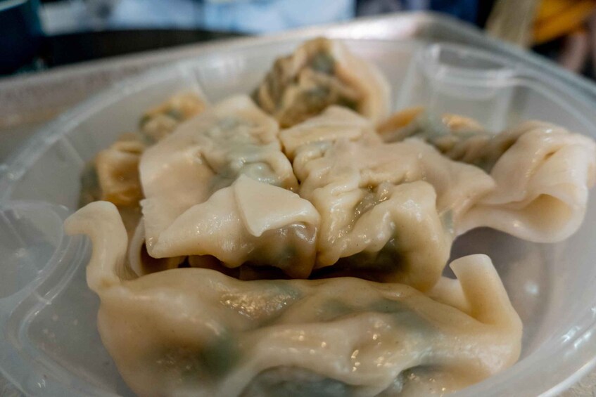 A plastic container filled with dumplings. 4