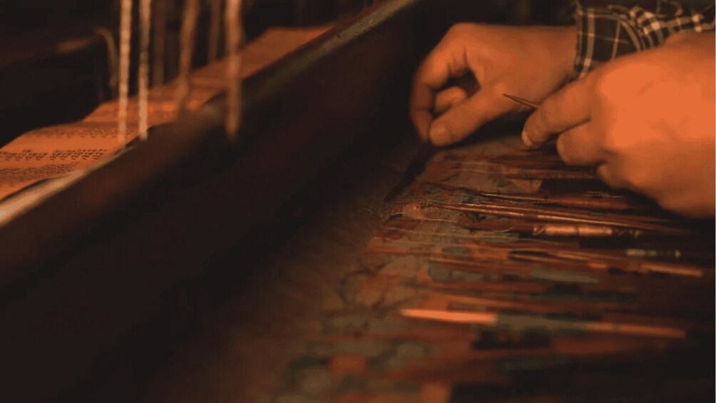 A person sewing with a needle and thread. 2