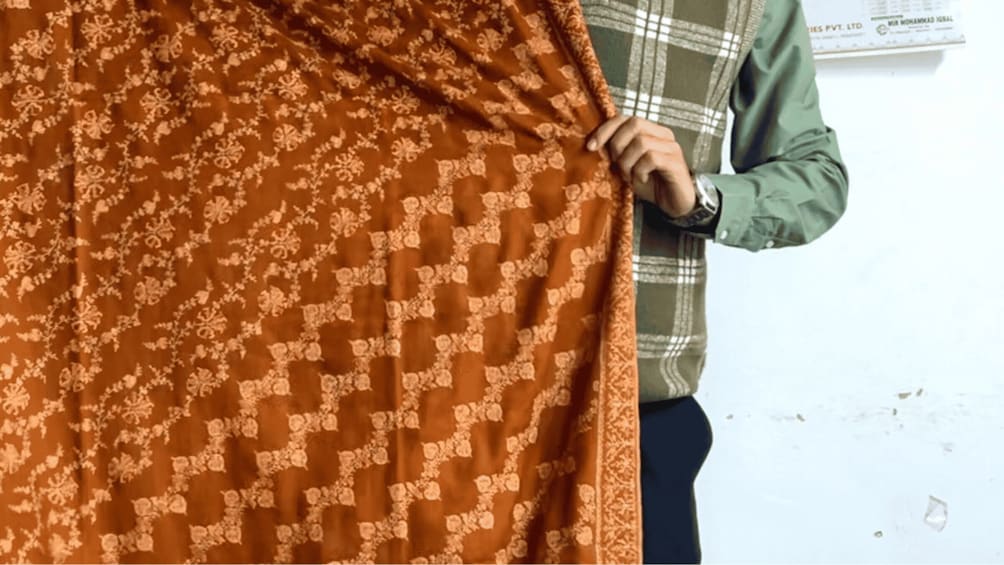 A person holding a patterned fabric. 3