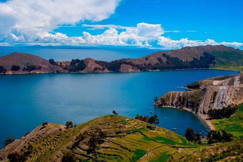 A lake surrounded by hills with terraced fields. 5