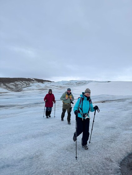 Three people hiking on a snow-covered landscape. 5