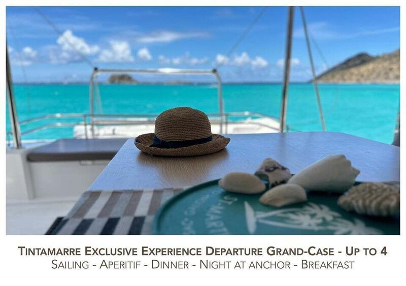 A boat deck with a straw hat and stones, and a sign indicating a sailing experience. 1