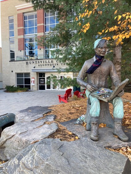 A statue of a man holding a palette, in front of a building labeled 'Huntsville Clinic.' 2