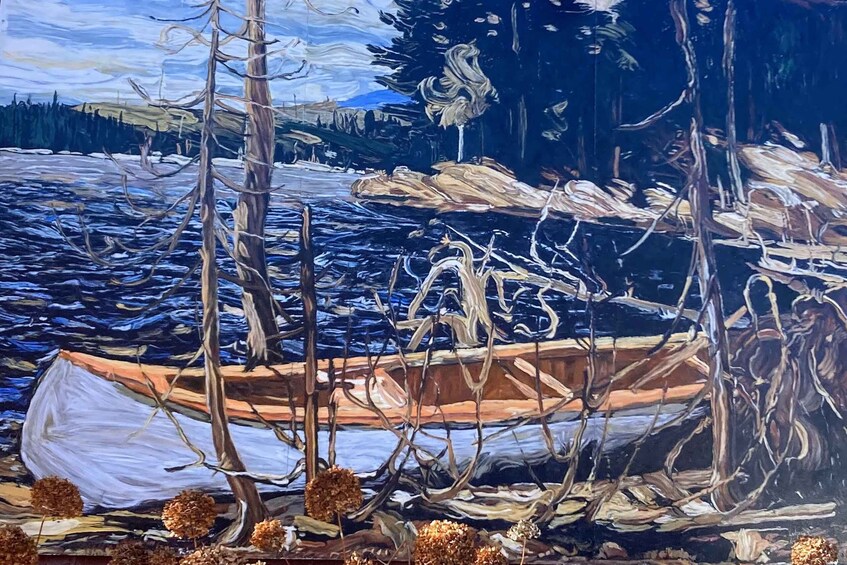 A boat on a riverbank with trees and a distant shoreline. 3